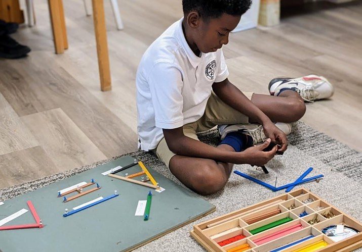 An Elementary student building shapes with the Montessori geometry sticks