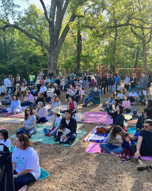 AIA families on picnic blankets outdoors for Movie on the Green